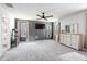 Main bedroom featuring a ceiling fan, mounted television, and gray accent wall at 1036 S Fieldhaven Dr, Fuquay Varina, NC 27526