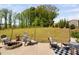 Relaxing outdoor patio featuring string lights, comfortable chairs, and a stone fire pit for cozy evenings at 1036 S Fieldhaven Dr, Fuquay Varina, NC 27526