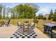 Outdoor patio features a table set for entertaining and a Blackstone grill for outdoor cooking at 1036 S Fieldhaven Dr, Fuquay Varina, NC 27526