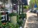 Lush planters decorate the sidewalk outside storefronts, enhancing the vibrant downtown atmosphere at 1036 S Fieldhaven Dr, Fuquay Varina, NC 27526