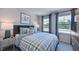 Comfortable bedroom with plaid bedding, blue accents, and natural light creating a cozy retreat at 104 Sodalite Ln, Holly Springs, NC 27540
