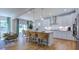 Modern kitchen with island seating, stainless appliances, white cabinets, and an open dining area at 104 Sodalite Ln, Holly Springs, NC 27540