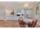 Basement with wet bar, white cabinets, and a table with chairs at 108 Monarch Way, Cary, NC 27518
