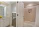 Bright bathroom featuring a tub and shower combo, toilet and white vanity with doorway to closet at 108 Monarch Way, Cary, NC 27518