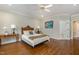 Comfortable bedroom featuring a classic bed frame, hardwood floors, and ample natural light at 108 Monarch Way, Cary, NC 27518