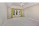 Bright, airy bedroom with neutral walls, carpet, a ceiling fan and a large window overlooking trees at 108 Monarch Way, Cary, NC 27518