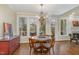 Charming breakfast room with large windows, chandelier, and access to the deck at 108 Monarch Way, Cary, NC 27518