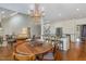 Elegant dining area features a chandelier, hardwood floors, and seamless flow to the kitchen at 108 Monarch Way, Cary, NC 27518