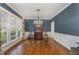Elegant dining room with blue textured wallpaper, chandelier, and hardwood floors at 108 Monarch Way, Cary, NC 27518