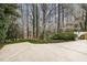 A concrete driveway surrounded by trees and well-maintained landscaping at 108 Monarch Way, Cary, NC 27518