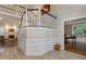 Bright and airy home foyer featuring tile floor, wood staircase and an office through open doorway at 108 Monarch Way, Cary, NC 27518