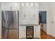 Kitchen featuring stainless steel refrigerator, wine fridge, and ample cabinet space at 108 Monarch Way, Cary, NC 27518