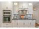Modern kitchen featuring stainless steel appliances, granite countertops, and stylish backsplash at 108 Monarch Way, Cary, NC 27518