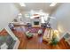 Aerial view of living room showcasing hardwood floors, fireplace, skylights and comfortable seating arrangement at 108 Monarch Way, Cary, NC 27518