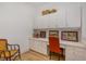Home office featuring built-in cabinets, desk space, and a bright orange chair at 108 Monarch Way, Cary, NC 27518