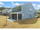 This exterior shot reveals a screened in patio, concrete slab, and lush lawn at 1120 Copper Beech Ln, Wake Forest, NC 27587