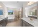 A bathroom featuring double sinks, a soaking tub, and separate glass enclosed shower at 1120 Copper Beech Ln, Wake Forest, NC 27587