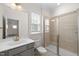 Bathroom with white vanity, walk-in shower, and sliding glass door at 1120 Copper Beech Ln, Wake Forest, NC 27587