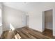 Sunlit bedroom featuring wood floors and neutral walls with easy access to closet and bathroom at 1120 Copper Beech Ln, Wake Forest, NC 27587