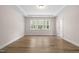 Bedroom featuring a hardwood floor, a window, recessed lighting, and white trim at 1120 Copper Beech Ln, Wake Forest, NC 27587