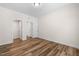 Bedroom with neutral walls, wood floor, closet and two entry doors at 1120 Copper Beech Ln, Wake Forest, NC 27587
