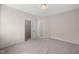Bright bedroom featuring neutral walls, plush carpet, and an open closet and bathroom doorway at 1120 Copper Beech Ln, Wake Forest, NC 27587