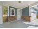 Covered front porch with neutral colors and stone accents providing an inviting curb appeal at 1120 Copper Beech Ln, Wake Forest, NC 27587