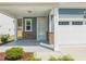 Inviting front porch with stone accents, white columns, and a well-maintained entrance to this home at 1120 Copper Beech Ln, Wake Forest, NC 27587