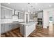 Modern kitchen with gray cabinets, stainless steel appliances, and center island with white countertop at 1120 Copper Beech Ln, Wake Forest, NC 27587