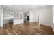 Open kitchen with gray cabinets, stainless steel appliances, island and hardwood floors at 1120 Copper Beech Ln, Wake Forest, NC 27587