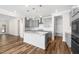 Open-concept kitchen featuring a center island, stainless steel appliances, and gray cabinetry at 1120 Copper Beech Ln, Wake Forest, NC 27587