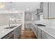 Bright kitchen with white backsplash, gray cabinets, stainless appliances, and a large kitchen island at 1120 Copper Beech Ln, Wake Forest, NC 27587