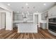 Modern kitchen with stainless steel appliances, gray cabinets, white countertops, and stylish pendant lighting at 1120 Copper Beech Ln, Wake Forest, NC 27587