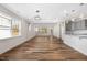 Spacious living room featuring hardwood floors, large windows, and modern lighting fixtures at 1120 Copper Beech Ln, Wake Forest, NC 27587