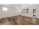 Bright Living Room with large windows overlooking backyard with lush landscaping at 1120 Copper Beech Ln, Wake Forest, NC 27587