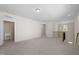 Bright loft with neutral carpet, recessed lighting and stairway access to additional floors and a view into a bathroom at 1120 Copper Beech Ln, Wake Forest, NC 27587