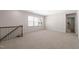 Bright loft with neutral carpet, recessed lighting and stairway access to additional floors and doorway to additional rooms at 1120 Copper Beech Ln, Wake Forest, NC 27587