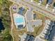Aerial view of the community pool, playground, parking lot and other community amenities at 1120 Copper Beech Ln, Wake Forest, NC 27587