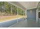 Screened porch with speckled flooring and beautiful views of the fenced-in backyard and woods at 1120 Copper Beech Ln, Wake Forest, NC 27587