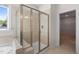 A close-up of a glass-enclosed shower next to a soaking tub, featuring bright neutral tile at 1120 Copper Beech Ln, Wake Forest, NC 27587