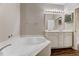 Primary bathroom features large soaking tub, double vanity and modern lighting at 1123 Claret Ln, Morrisville, NC 27560
