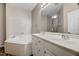 Bathroom featuring soaking tub, double sink vanity and modern lighting at 1123 Claret Ln, Morrisville, NC 27560