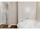 Bathroom featuring soaking tub with shower and glass door at 1123 Claret Ln, Morrisville, NC 27560