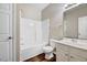 Bright bathroom with a white tub and shower combo, classic vanity, and wood-look flooring at 1123 Claret Ln, Morrisville, NC 27560