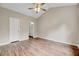 Spacious bedroom featuring vaulted ceilings and wood-look flooring. Doorway to ensuite bathroom at 1123 Claret Ln, Morrisville, NC 27560