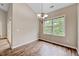 Bright dining room featuring wood floors, chandelier and a large window letting in plenty of natural light at 1123 Claret Ln, Morrisville, NC 27560