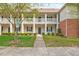 Charming two-story condo with classic architecture, beautiful landscaping and inviting walkway to the main entrance at 1123 Claret Ln, Morrisville, NC 27560