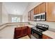 Well-equipped kitchen featuring wooden cabinets, modern appliances, and ample counter space for cooking at 1123 Claret Ln, Morrisville, NC 27560
