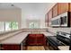Modern kitchen with stainless steel appliances, wood cabinets, and granite countertops at 1123 Claret Ln, Morrisville, NC 27560