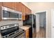 Functional kitchen featuring wooden cabinets and modern stainless steel appliances for convenient cooking at 1123 Claret Ln, Morrisville, NC 27560